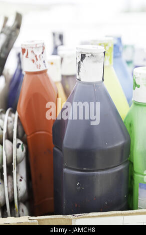 Bottles of acrylic paint colors in art studio, profession Stock Photo