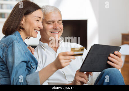 Mature couple using credit card to shop online Stock Photo