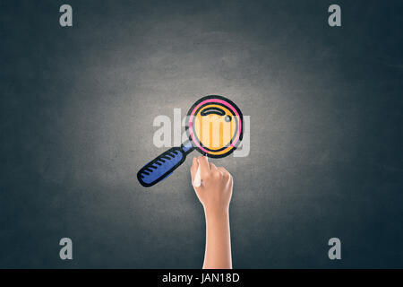 Woman writing magnifying glass icon on blackboard Stock Photo