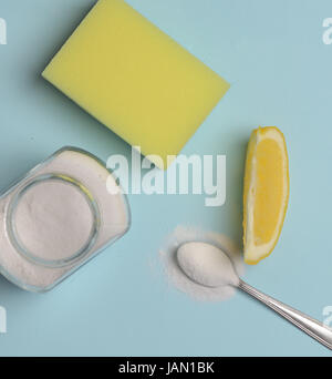 Sodium bicarbonate in a glass, lemon and sponge Stock Photo