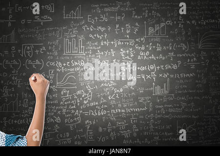 Women hand writing mathematical formulas on blackboard Stock Photo
