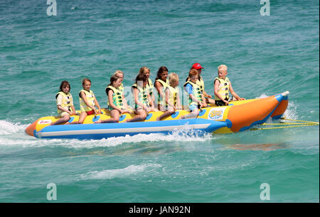 ALCUDIA , MAJORCA, SPAIN - 8th August 2013: Children enjoying a banana boat ride in Alcudia on the 8th August 2013. Stock Photo