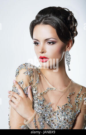 Elegance. Luxurious Good Looking Woman in Dress with Sequins and Jewels Stock Photo