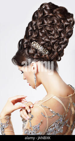 Luxury. Fashion Model with Trendy Updo - Braided Tress. Vogue Style Stock Photo