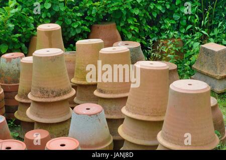 Large group of terracotta gardening pots standing upside down Stock Photo