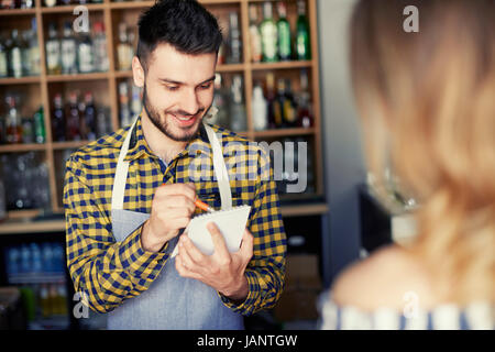 Barman taking an order from customer Stock Photo