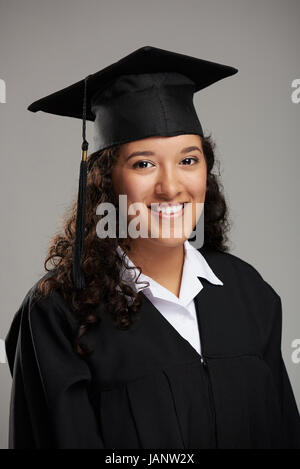Smiling pretty hispanic graduated student girl studio portrait Stock Photo