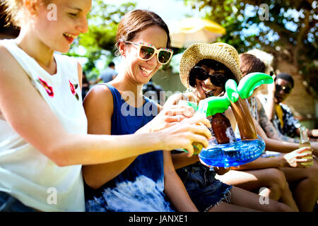 Group of diverse friends celebrating drinking beers together Stock Photo