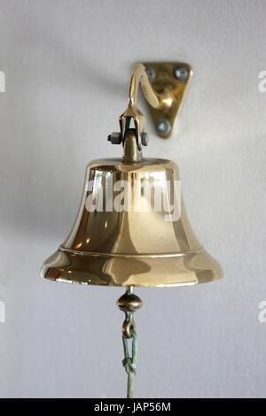 Vintage brass bell mounted on a wall Stock Photo