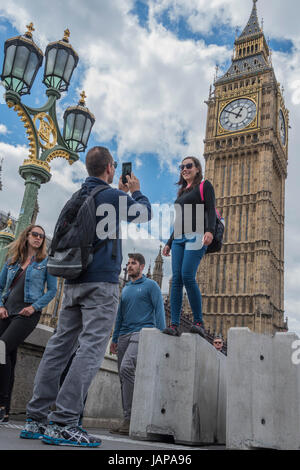 London, UK. 07th June, 2017. Tourists seem happy to find alternative uses for the new security barriers on Westminster Bridge. London 07 June 2017. Credit: Guy Bell/Alamy Live News Stock Photo