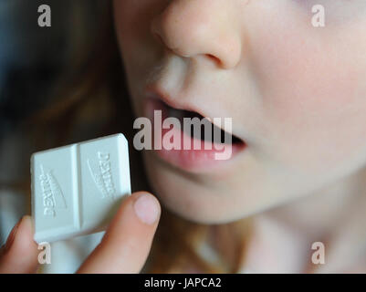 FILE - A file picture dated 26 April 2011 shows a girl bringing a piece of Dextro Energy to her mouth, in Berlin, Germany. The European Court of Justice is due to make a ruling on advertising sugar on 8 June 2017. Photo: Jens Kalaene/dpa-Zentralbild/dpa Stock Photo