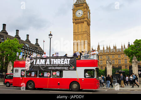 Westminster, London, UK, 7th June 2017. A red double decker bus branding Theresa May a 'Threat' travels around Westminster on the day before the UK General Election. The bus  is an initiative by The People's Assembly, a pressure group initially formed to protest austerity measures. The movement has in the past received support from the UK Trade Unions, as well as Labour MPs. Credit: Imageplotter News and Sports/Alamy Live News Stock Photo
