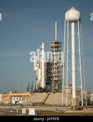 The SpaceX Falcon 9 rocket, with the Dragon spacecraft onboard, is seen shortly after being raised vertical at Launch Complex 39A at NASA·s Kennedy Space Center in Cape Canaveral, Florida, Thursday, June 1, 2017. Dragon is carrying almost 6,000 pounds of science research, crew supplies and hardware to the International Space Station in support of the Expedition 52 and 53 crew members. The unpressurized trunk of the spacecraft also will transport solar panels, tools for Earth-observation and equipment to study neutron stars. This will be the 100th launch, and sixth SpaceX launch, from this pad. Stock Photo