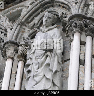 Detail of the West Front of Nidaros Cathedral:  a statue of Saint Nicasius, archbishop of Reims, who was beheaded by the Vandals on the steps of his c Stock Photo