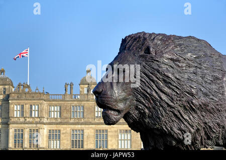 Longleat House, Wiltshire, UK. 17th March, 2016. A magnificent sculpture of a lion by African based sculptor Bruce Little. Stock Photo