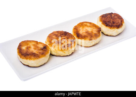 Fried curd cheese cakes on white background. Stock Photo