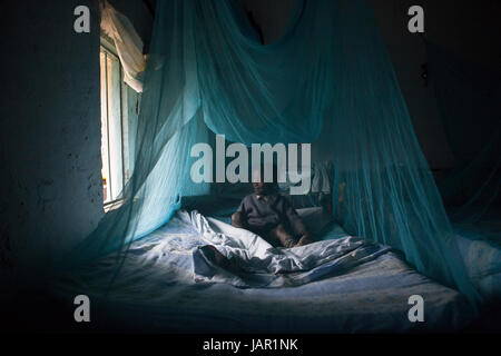 A child underneath a mosquito net, Kenya, Africa Stock Photo