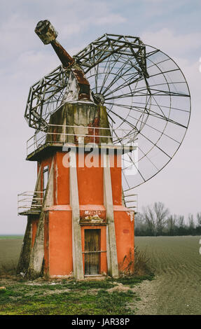 Retro future: broken and abandoned radio telescope in the plain of the Po valley near to Bologna, Italy. Stock Photo