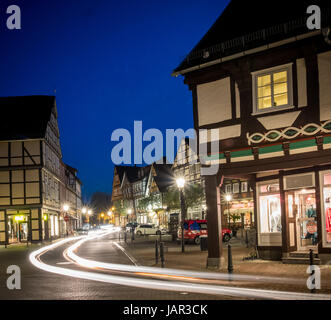 Light trace of cars going through the medieval / old town part of Celle, Lower Saxony, Germany at night. Stock Photo