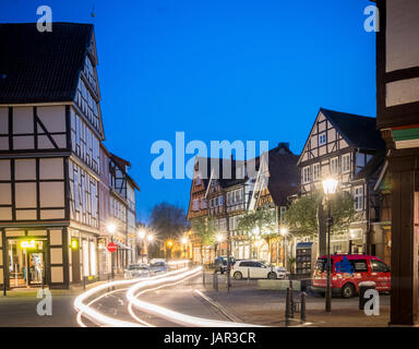 Light trace of cars going through the medieval / old town part of Celle, Lower Saxony, Germany at night. Stock Photo