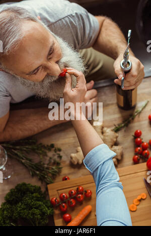 Woman feeding man Stock Photo