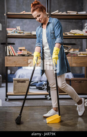 Woman sweeping floor   Stock Photo