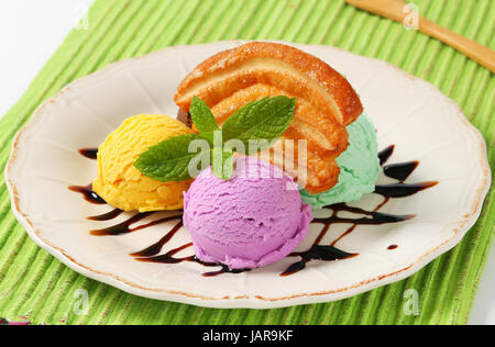 Scoops of ice cream with puff pastry biscuit and chocolate sauce Stock Photo