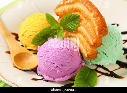 Scoops of ice cream with puff pastry biscuit and chocolate sauce Stock Photo