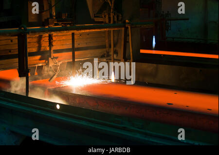 Gas cutting of the hot metal inside of plant Stock Photo