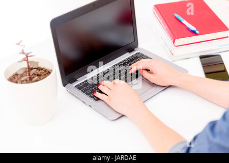 Womans hands on notebook working in clean and bright office, at home, freelance Stock Photo