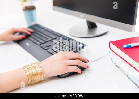 Womans hands on notebook working in clean and bright office, at home, freelance Stock Photo
