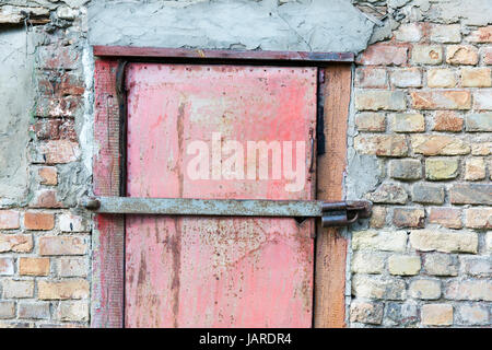 metal door in garage brick wall background Stock Photo