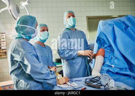 team of surgeons and nurses performing laparoscopic minimally invasive surgery Stock Photo