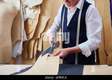 Mature Tailor Making Garments in Atelier Studio Stock Photo