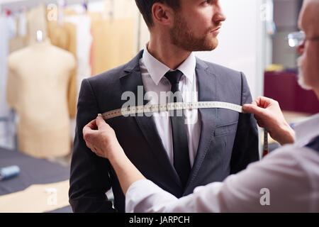 Handsome Customer at Model Fitting in Atelier Stock Photo
