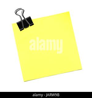 Single yellow sticky note with paper clip isolated on white Stock Photo