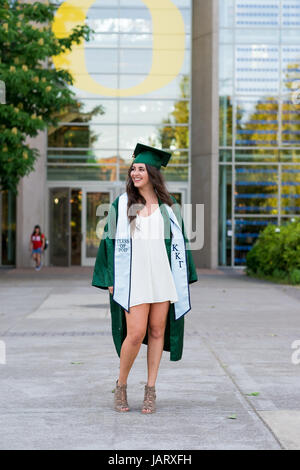 EUGENE, OR - MAY 23, 2017: Female college student posing for graduation photos in the Lillis Business Plaza on campus at the University of Oregon in E Stock Photo