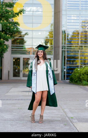 EUGENE, OR - MAY 23, 2017: Female college student posing for graduation photos in the Lillis Business Plaza on campus at the University of Oregon in E Stock Photo