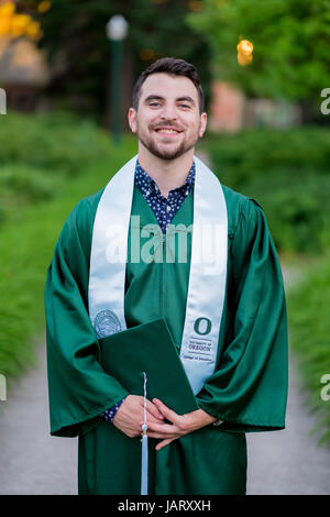 eugene or may 23 2017 male college student with cap and gown poses