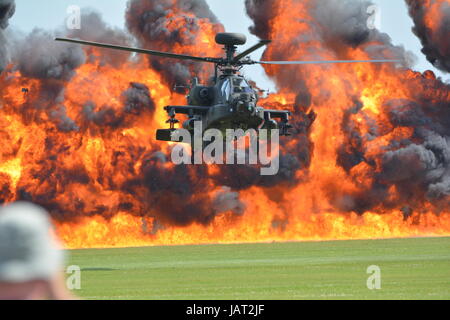 Apache  Attack helicopter with pyro technic explosion fire ball background Stock Photo