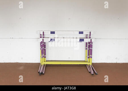 Running Hurdles inside the sports center, sports Stock Photo