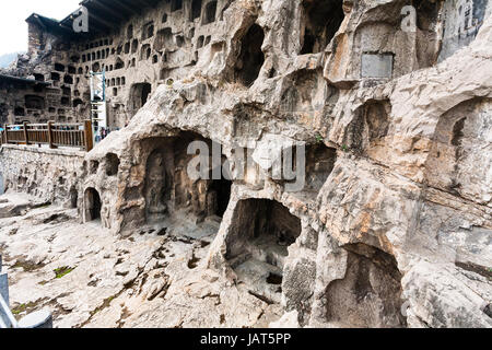 LUOYANG, CHINA - MARCH 20, 2017: caves and Grottoes in wall of West Hill of Chinese Buddhist monument Longmen Grottoes. The complex was inscribed upon Stock Photo