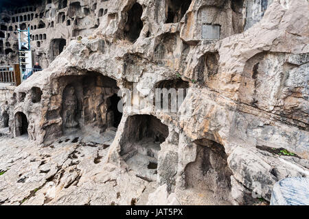 LUOYANG, CHINA - MARCH 20, 2017: visitor near caves and Grottoes in West Hill of Chinese Buddhist monument Longmen Grottoes. The complex was inscribed Stock Photo