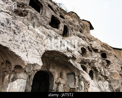 LUOYANG, CHINA - MARCH 20, 2017: carved slope of caves in West Hill of Chinese Buddhist monument Longmen Grottoes. The complex was inscribed upon the  Stock Photo