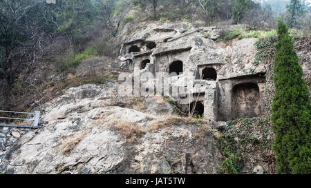 LUOYANG, CHINA - MARCH 20, 2017: caves in slope of West Hill of Chinese Buddhist monument Longmen Grottoes. The complex was inscribed upon the UNESCO  Stock Photo