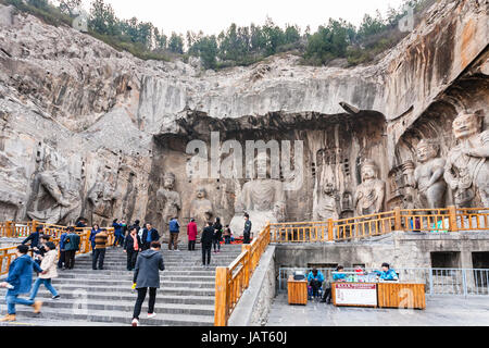 LUOYANG, CHINA - MARCH 20, 2017: people near The Big Vairocana sculpture in main Longmen Grottoes (Longmen Caves). The complex was inscribed upon the  Stock Photo