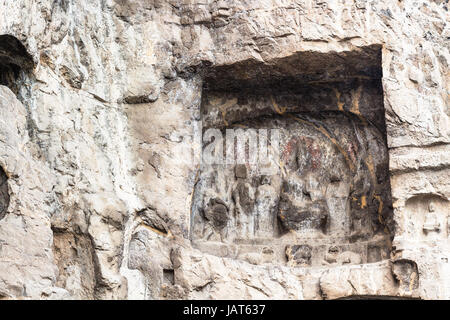 LUOYANG, CHINA - MARCH 20, 2017: reliefs in cave of Chinese Buddhist monument Longmen Grottoes (Longmen Caves). The complex was inscribed upon the UNE Stock Photo