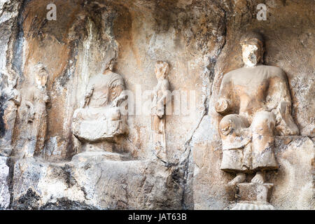 LUOYANG, CHINA - MARCH 20, 2017: carved statues in cave of Longmen Grottoes (Longmen Caves). The complex was inscribed upon the UNESCO World Heritage  Stock Photo