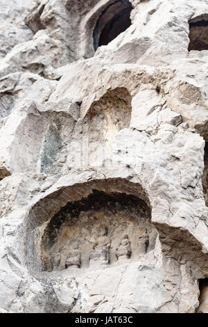 LUOYANG, CHINA - MARCH 20, 2017: caves with reliefs in Chinese Buddhist monument Longmen Grottoes (Longmen Caves). The complex was inscribed upon the  Stock Photo