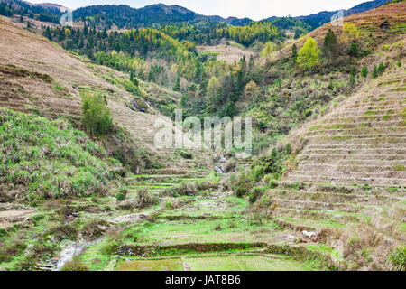travel to China - view of terraced hills and creek in Dazhai village in country of Longsheng Rice Terraces (Dragon's Backbone terrace, Longji Rice Ter Stock Photo